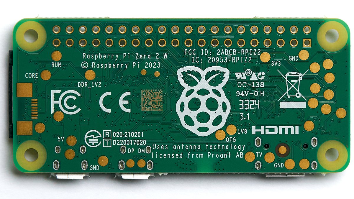 A Raspberry Pi Zero 2 W. Note the pad layout for the unpopulated 40-pin GPIO header (top edge), the micro-USB ports along the side (the inner one is OTG data + power; the outer one is power-only), …